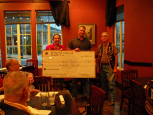 Sandi Schendel, President of the Auxilliary at Post 179, and Shayne Guillot, Treasurer and a coach in the New Braunfels Little League, receive our donations for sponsorship from President Grey Baker