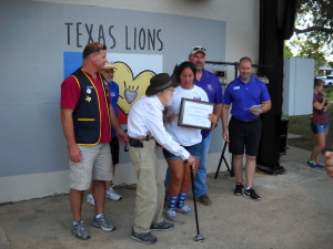 Lion Lin Rose presents the scholarship in his name.